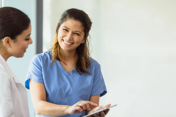 istock Female colleagues discuss patient test results displayed on tablet 1303713840