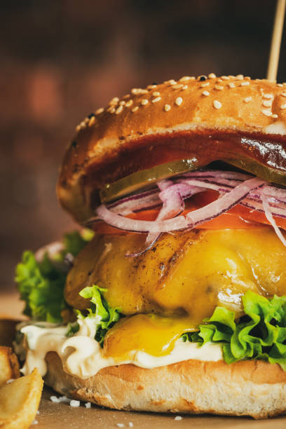 istock Big Cheese Burger Close Up. Beef Hamburger with Fresh Vegetables 1303715426