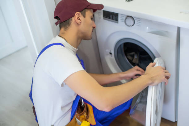 istock Handyman fixing a washing machine in the bathroom 1303715459