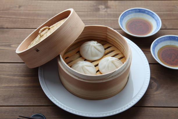 istock xiaolongbao Chinese steamed bun mantou dumpling on wooden table 1303715516
