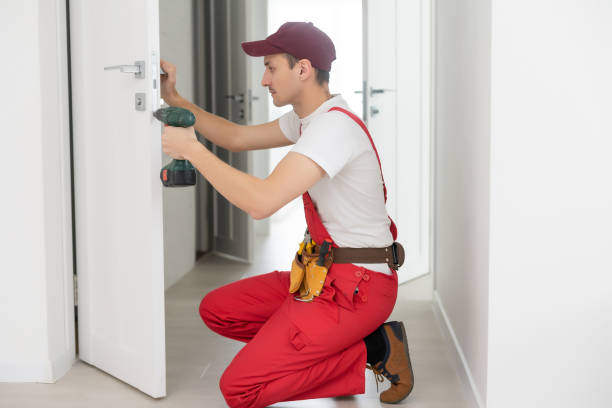 istock The master worker installs a door lock in the front door, metal doors with a polymer coating 1303716363