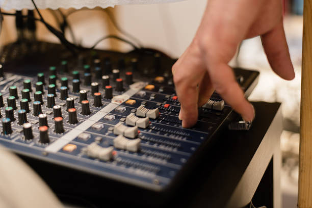 istock DJ setup at a party. DJ is touching regulators 1303716443