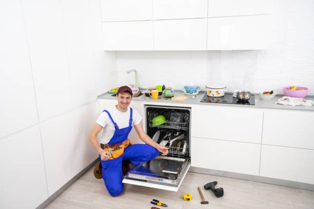 istock Happy master. Male technician sitting near dishwasher with screwdriver in kitchen with instruments and smiling 1303716610