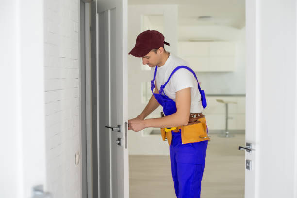 istock The master worker installs a door lock in the front door, metal doors with a polymer coating 1303716755