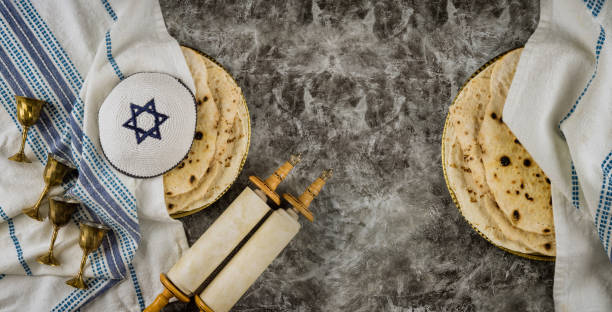 orthodox jewish family symbols with cup wine kosher matzah on traditional jewish passover holiday scrolls torah - passover imagens e fotografias de stock
