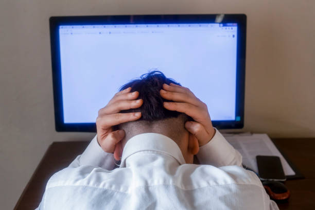 istock Tired young businessman working at home 1303716985