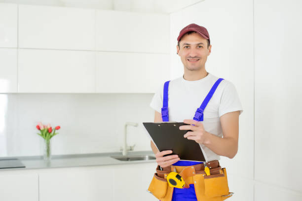 istock Smiling male architect with clipboard and pen against a white background. 1303717016