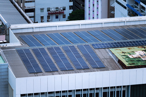 Row of solar panel on roof of building in downtown. Photovoltaic solar cell innovation of renewable and sustainable energy