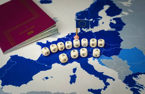 Passport and Schengen Area message over a Map of the of the 26 countries that compose the Schengen Zone . Concept of ETIAS or European Travel Information and Authorisation System. Expected to enter into operation in 2022