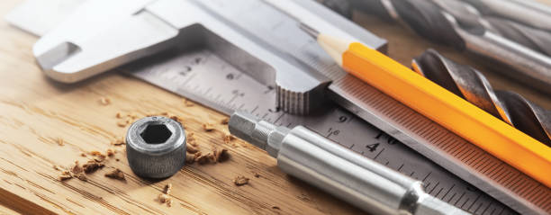 istock hex bolt screwed by hex bit with ruler and caliper, pencil  in wood oaks plate. Spanner, bolt, screw and nuts. 1303721801
