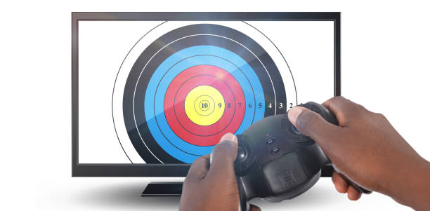 Hand of man playing video game against white background against close-up of blank computer monitor