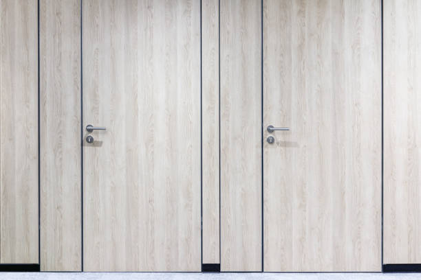 istock Two Invisible wooden doors in a row in the modern office 1303724249