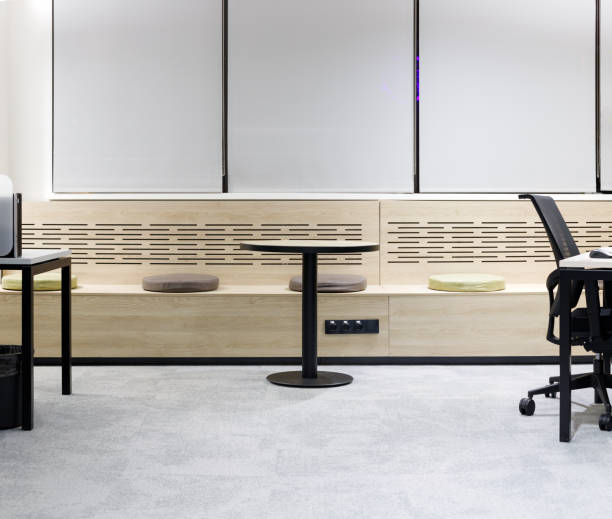 istock Lounge area with a table and seat cushions in a modern office 1303724312