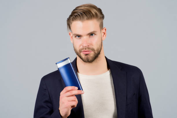 istock Man with shampoo or conditioner bottle 1303724960