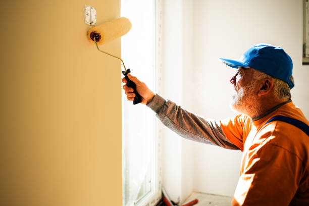 istock A middle-aged painter paints the walls in a building 1303727391