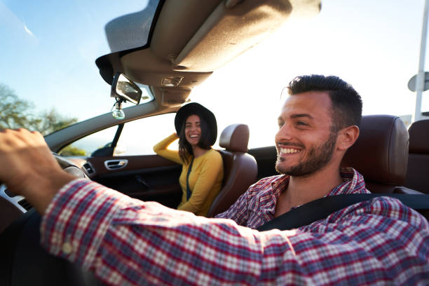 istock Young couple enjoying time in a convertible car 1303728076