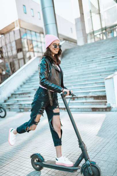 istock Modern Female Enjoying Electric Scooter Fun Outside 1303729498