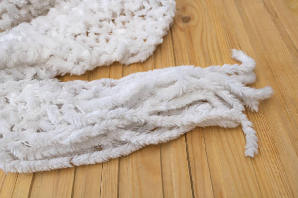 istock A white scarf on a wooden background 1303729499
