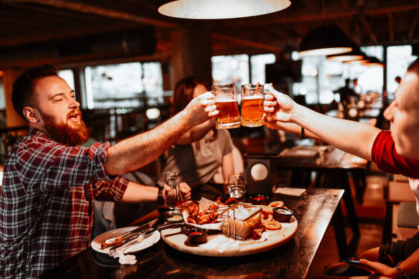 istock Friends Making Beer Celebratory Toast During Dinner Time In Restaurant 1303729604