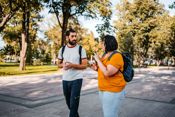 Two young people speak in sign language Two deaf and hard hearing people speak in sign language. american sign language stock pictures, royalty-free photos & images