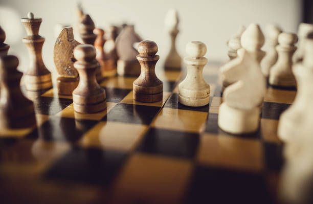 istock Wooden chess pieces on the chessboard. 1303730821