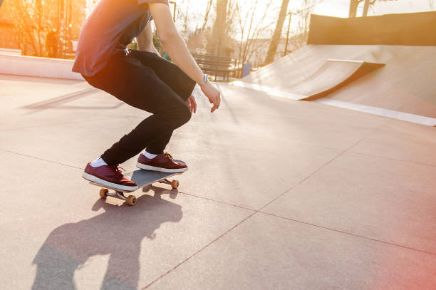 istock Unrecognizable skateboarder doing olie jump in skatepark 1303731825