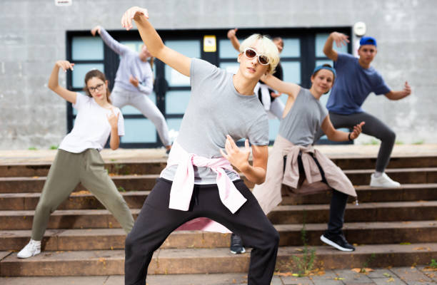 istock Modern teenager performing street dance with group 1303734134
