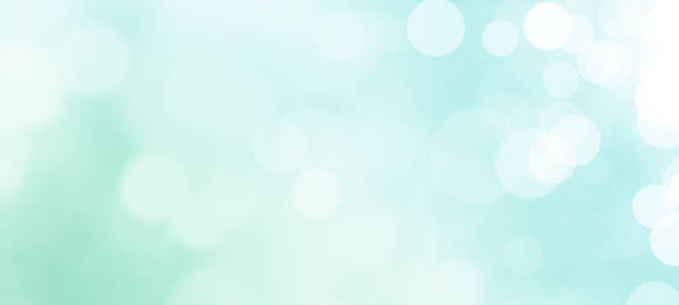 Bokeh Lights Background Defocused Lights over Green Background with Copy Space neon turquoise stock illustrations