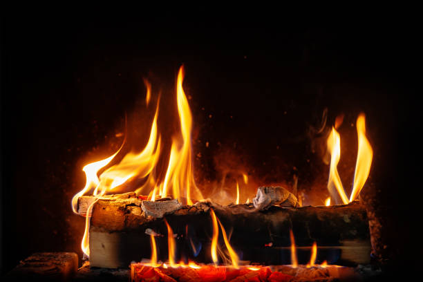 istock log fire and firewood in the fireplace for a cozy winter atmosphere 1303735331