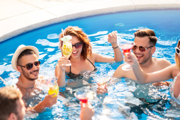 istock Enjoying pool party with friends 1303735787