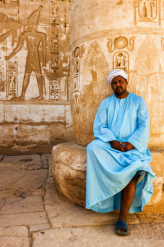 Egyptian man sitting in ancient temple and admires , Egypt