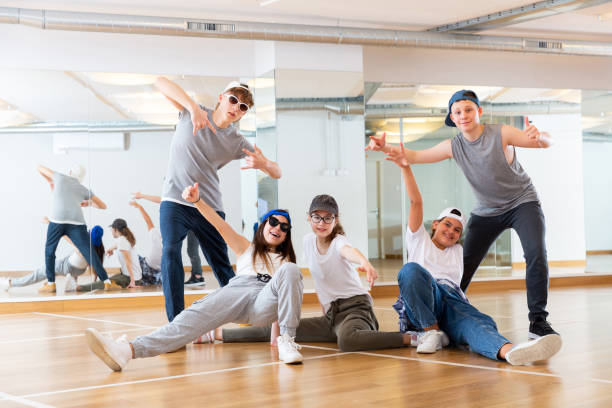 istock Group of dancing teenagers posing in dance studio 1303735855