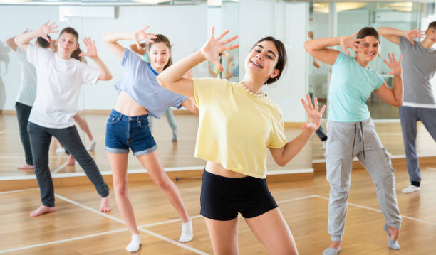 istock Diligent friendly smiling teenagers learn dance movements 1303735864