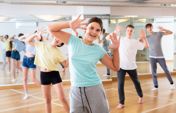 istock Diligent friendly smiling teenagers learn dance movements 1303735866
