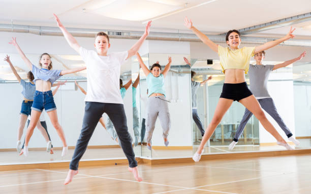 istock Teenagers jumping together during dance workout 1303735878