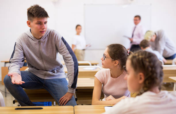 istock Teenager talking with classmates during recess in classroom 1303735957