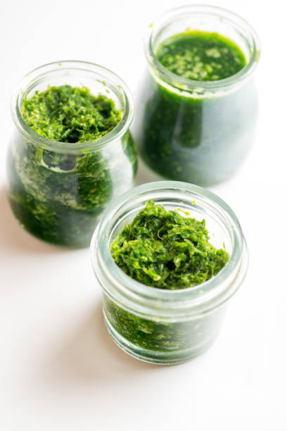 istock Pesto sauce in three jars on a white background 1303735969