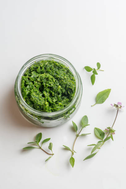istock pesto sauce in a jar on a white background 1303735975