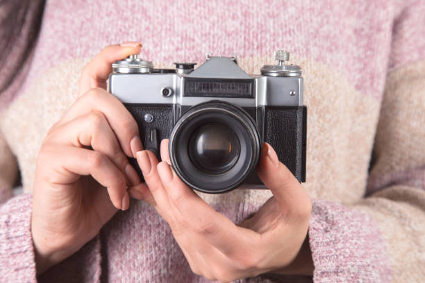 istock woman holding the vintage camera 1303736735