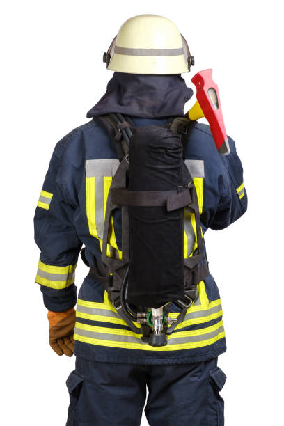 istock Back side view of firefighter in fire-proof uniform 1303737878