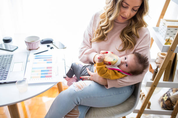 istock Woman with baby working on laptop 1303738423
