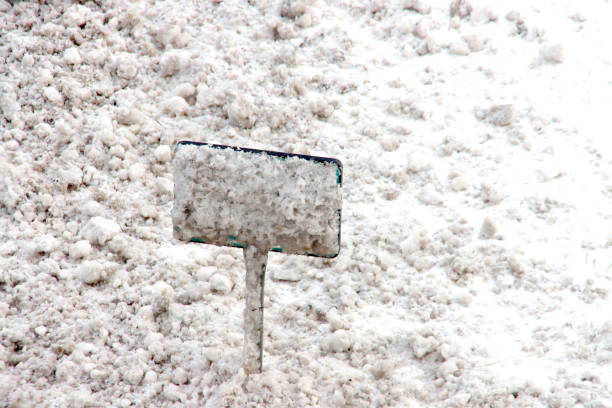 istock Snow on a distance sign colored by road salt 1303739056