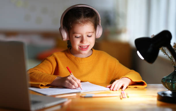 istock Little kid studying online at home 1303740431