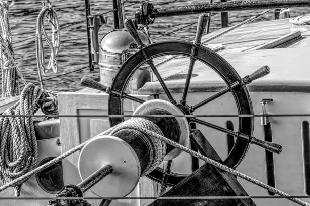 istock Black and White sailboat steering wheel and rigging. 1303740525