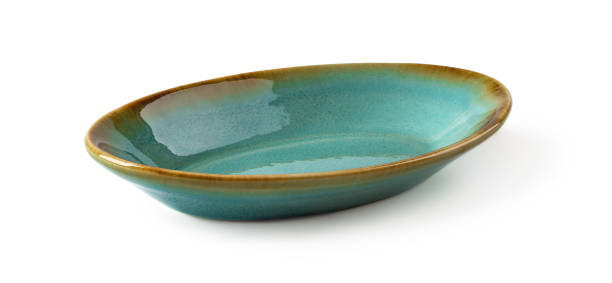 istock Side view of oblong turquoise ceramic plate isolated on a white background. Empty crockery for food design. Modern stylish dishes and tableware made of clay, ceramics and porcelain. 1303740647