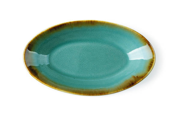 istock Top view of oblong turquoise ceramic plate isolated on a white background. Empty crockery for food design. Modern stylish dishes and tableware made of clay, ceramics and porcelain. 1303740660