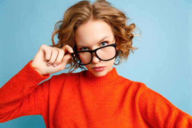 istock Curious woman in glasses looking at camera 1303741907