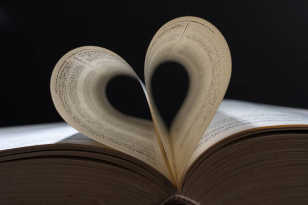 istock Close up heart shape from paper book on dark background. 1303742167