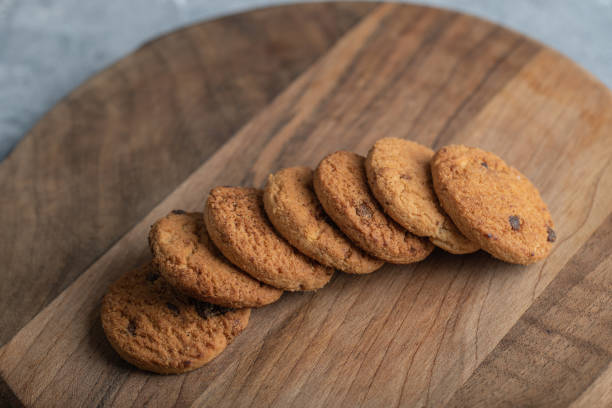 istock Stack of chocolate chip cookies on wooden board 1303743217