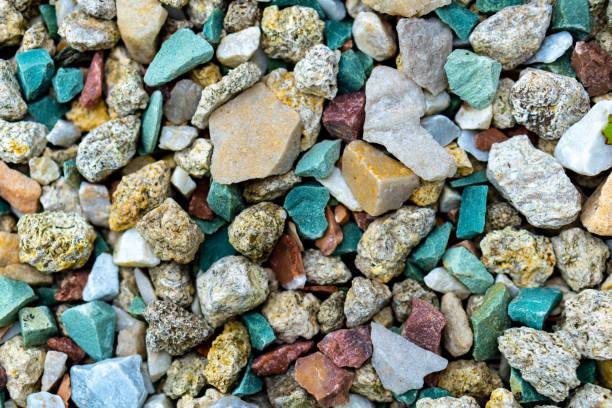 istock Sea pebbles. Pebble background. Wet stones. Multi-colored pebbles. Sea shore. Rocky texture from natural materials. Vacation, travel, building concept. 1303743444